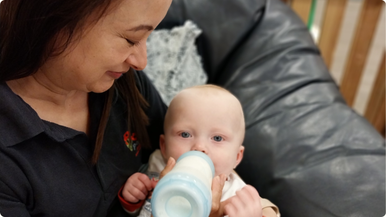 A baby being fed at the Poppies Tidworth Nursery: when is the right time to put my child into a nursery,
